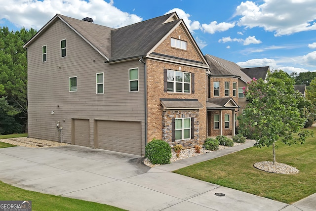 craftsman house with a front yard and a garage