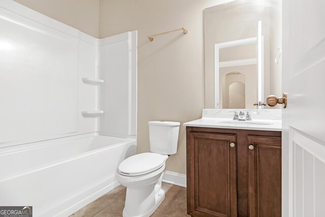 full bathroom with tile patterned floors, vanity, tub / shower combination, and toilet