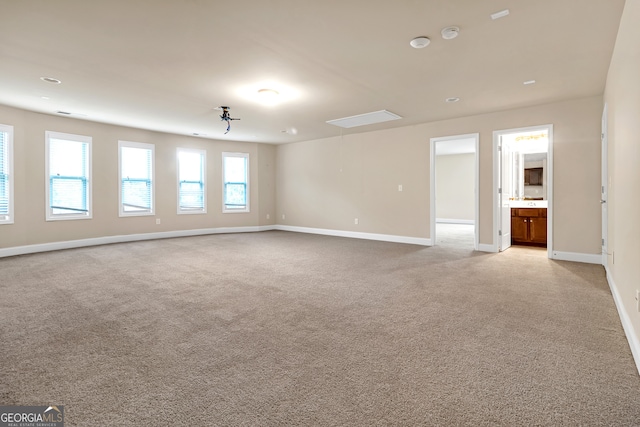 unfurnished room with light colored carpet