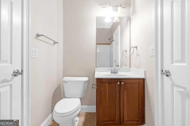 bathroom featuring vanity, toilet, and tile patterned flooring