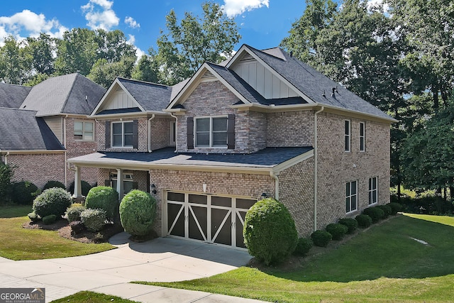 craftsman house featuring a front yard and a garage