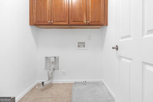 clothes washing area with hookup for an electric dryer, cabinets, light tile patterned floors, hookup for a washing machine, and gas dryer hookup