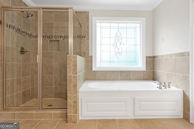 bathroom with tile patterned floors, independent shower and bath, and a healthy amount of sunlight