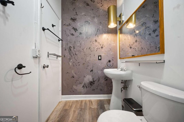 bathroom with sink, wood-type flooring, and toilet