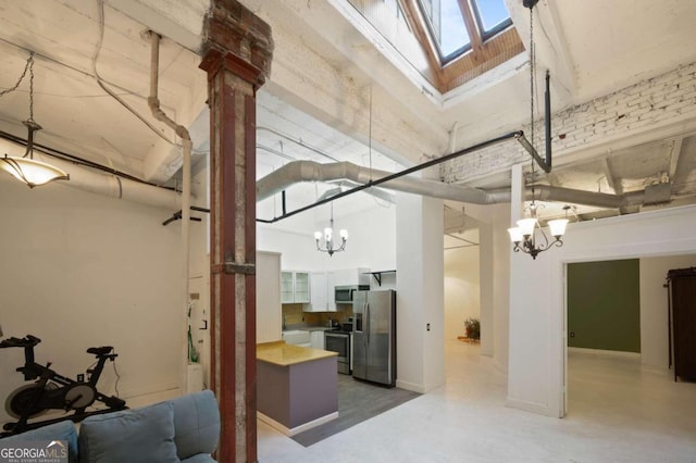 basement with an inviting chandelier and stainless steel fridge