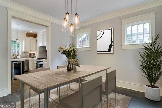 dining area with a wealth of natural light, ornamental molding, and dark hardwood / wood-style floors