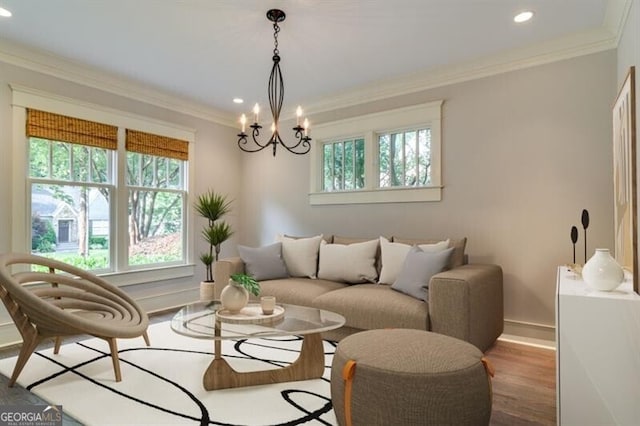 living room featuring crown molding, a healthy amount of sunlight, a chandelier, and wood-type flooring