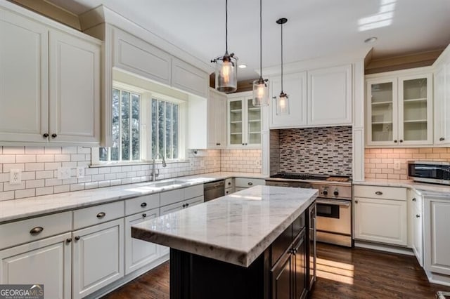 kitchen featuring white cabinets, tasteful backsplash, appliances with stainless steel finishes, and dark hardwood / wood-style floors