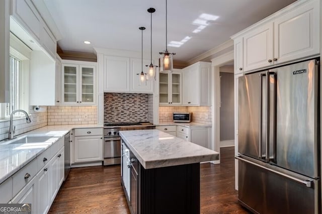 kitchen featuring white cabinetry, tasteful backsplash, sink, dark hardwood / wood-style flooring, and premium appliances