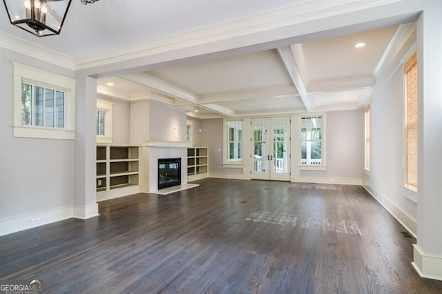 unfurnished living room featuring dark hardwood / wood-style flooring, coffered ceiling, ornamental molding, beam ceiling, and french doors