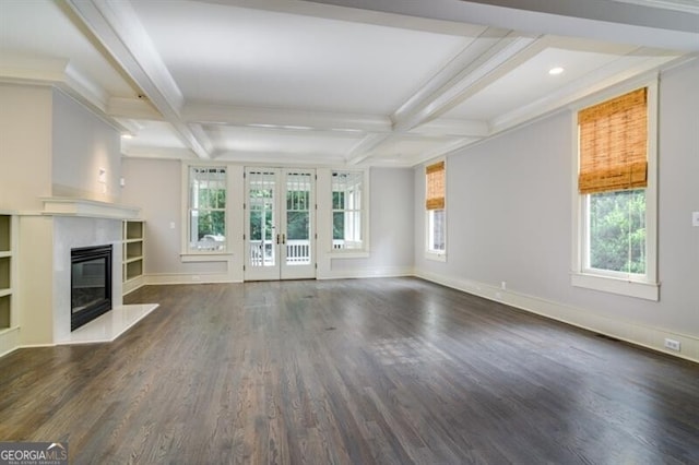 unfurnished living room featuring dark hardwood / wood-style flooring, beam ceiling, coffered ceiling, and a premium fireplace