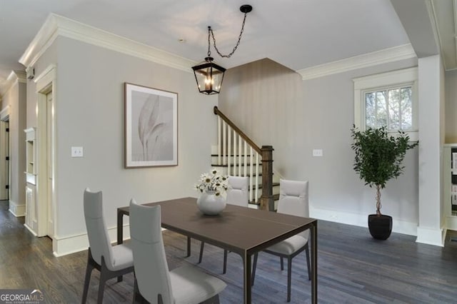 dining room featuring ornamental molding, dark hardwood / wood-style flooring, and an inviting chandelier