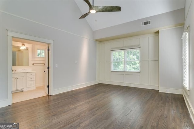 unfurnished bedroom with high vaulted ceiling, ceiling fan, hardwood / wood-style flooring, and ensuite bathroom