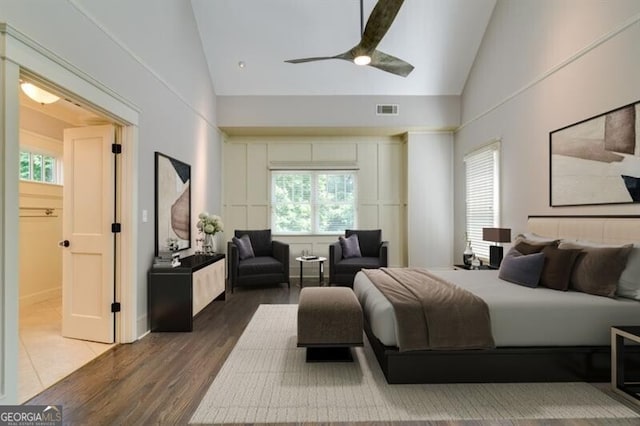 bedroom featuring ceiling fan, high vaulted ceiling, and dark wood-type flooring