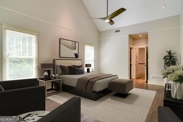 bedroom featuring ceiling fan, high vaulted ceiling, and wood-type flooring