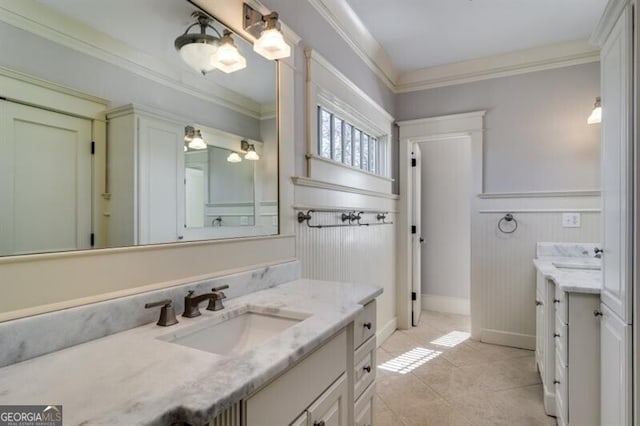 bathroom with tile patterned flooring, ornamental molding, and vanity