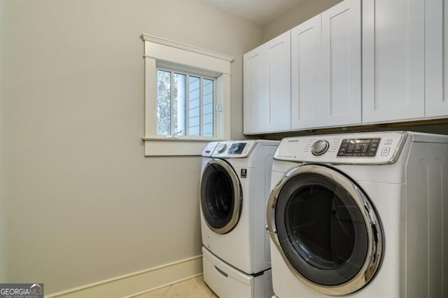 laundry area featuring cabinets, separate washer and dryer, and light tile patterned floors