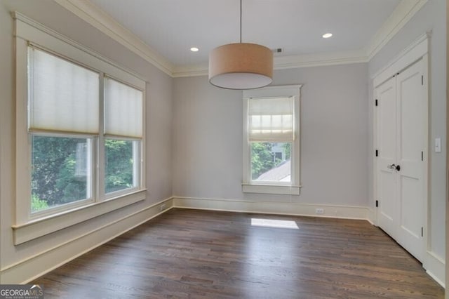 unfurnished dining area with dark hardwood / wood-style flooring, plenty of natural light, and crown molding