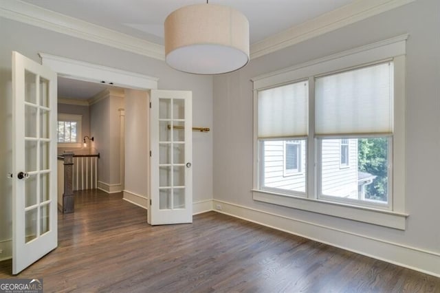 spare room featuring french doors, dark wood-type flooring, and ornamental molding