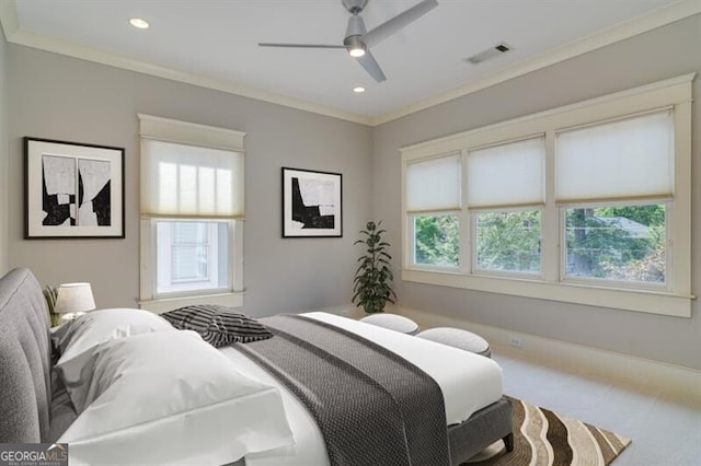 carpeted bedroom with ceiling fan, ornamental molding, and multiple windows