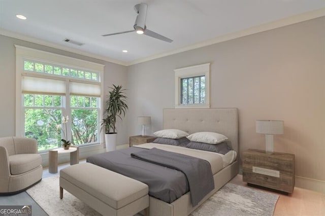 bedroom with ceiling fan, light wood-type flooring, and ornamental molding