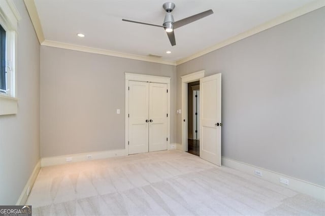 interior space with ceiling fan, crown molding, and light colored carpet