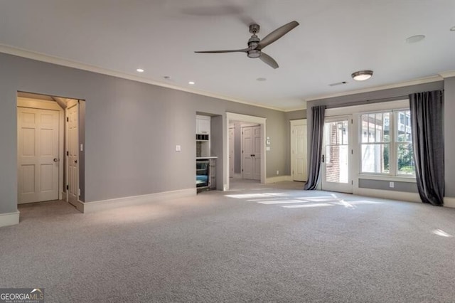 unfurnished living room with ceiling fan, ornamental molding, and light carpet