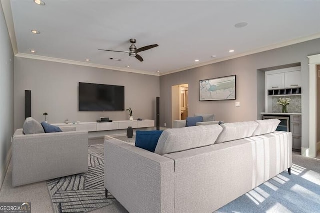 living room featuring ceiling fan, crown molding, and light colored carpet