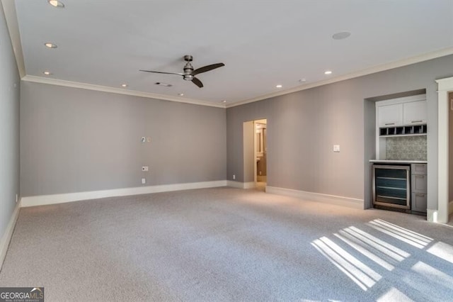 interior space with light colored carpet, ornamental molding, wine cooler, and ceiling fan