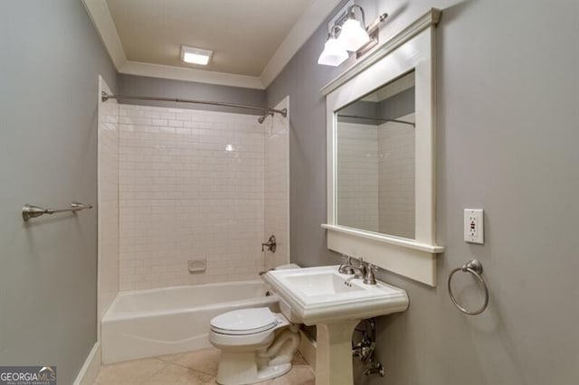 bathroom with toilet, tiled shower / bath combo, and tile patterned floors