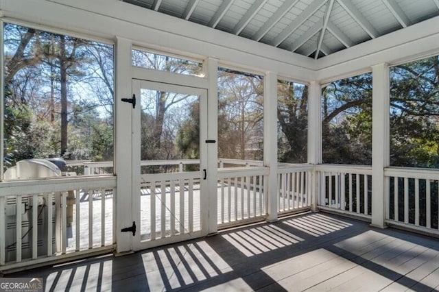 unfurnished sunroom with lofted ceiling with beams