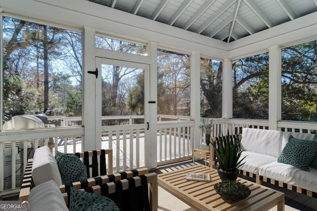 sunroom / solarium with vaulted ceiling with beams