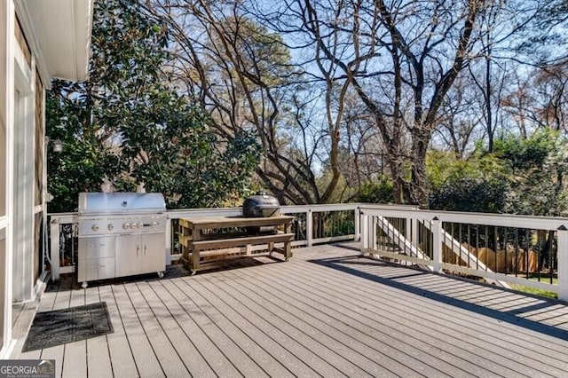 wooden deck featuring a grill