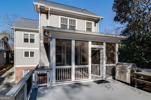 back of house featuring a sunroom