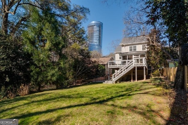 view of home's community featuring a wooden deck and a yard