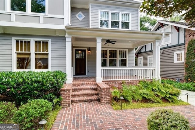 property entrance featuring ceiling fan and covered porch