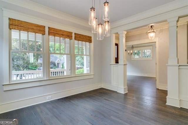 empty room featuring crown molding, ornate columns, and dark hardwood / wood-style floors