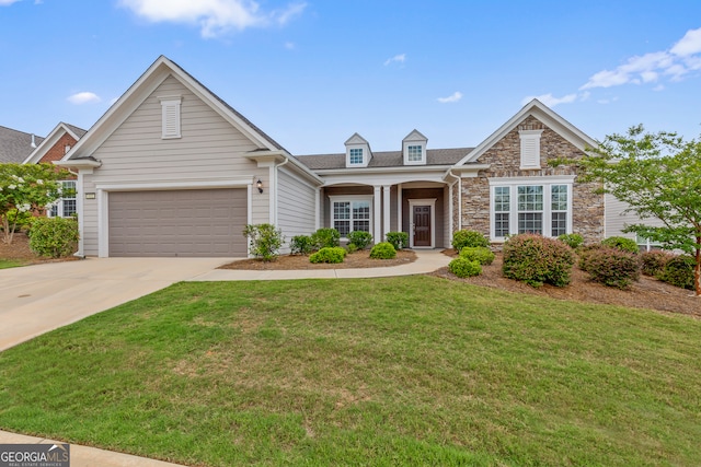 view of front of property with a garage and a front yard