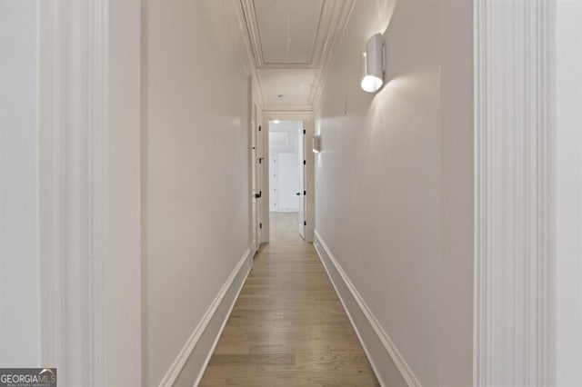 corridor featuring hardwood / wood-style floors and crown molding