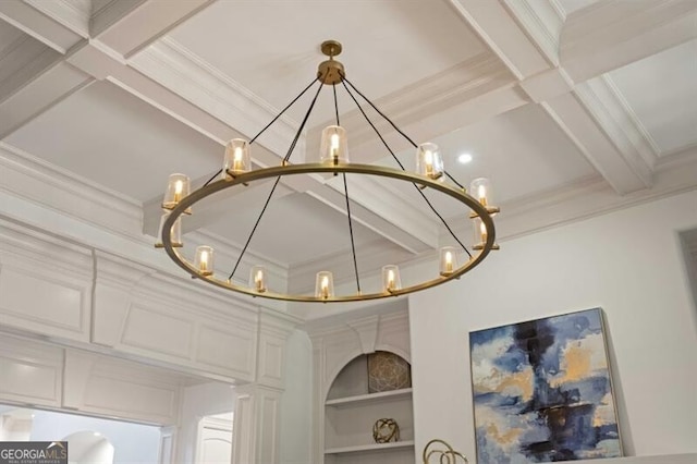 details with built in shelves, an inviting chandelier, coffered ceiling, beamed ceiling, and crown molding