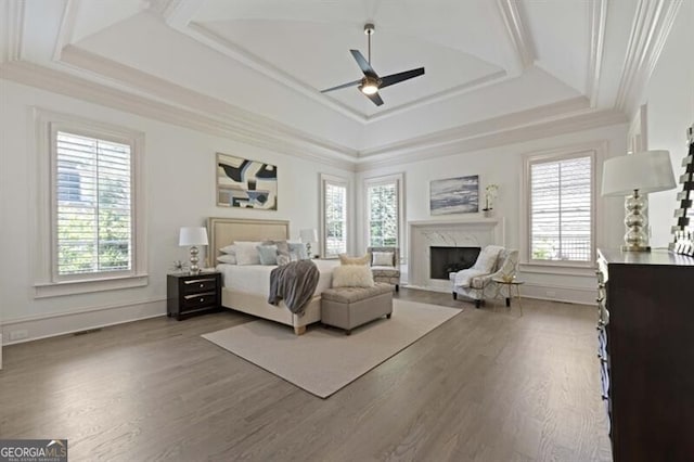 bedroom featuring multiple windows, ceiling fan, and wood-type flooring