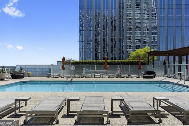 community pool featuring a patio area and fence