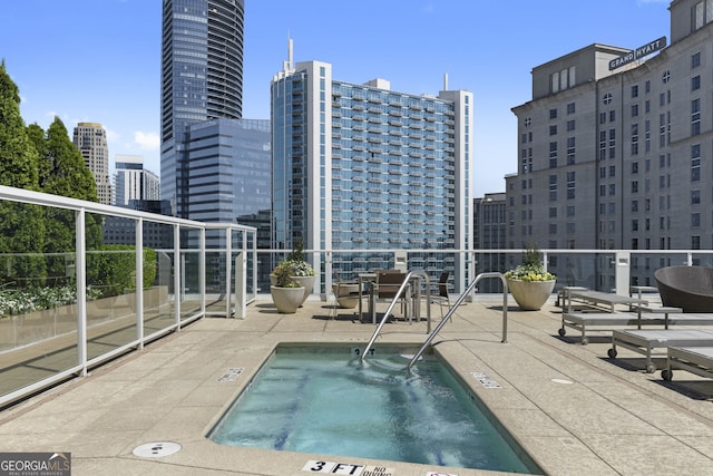 view of pool with a view of city