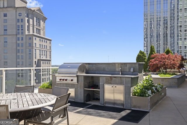 view of patio with a balcony, a grill, and exterior kitchen