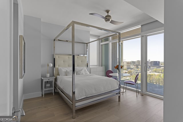 bedroom with ceiling fan, access to outside, and hardwood / wood-style flooring