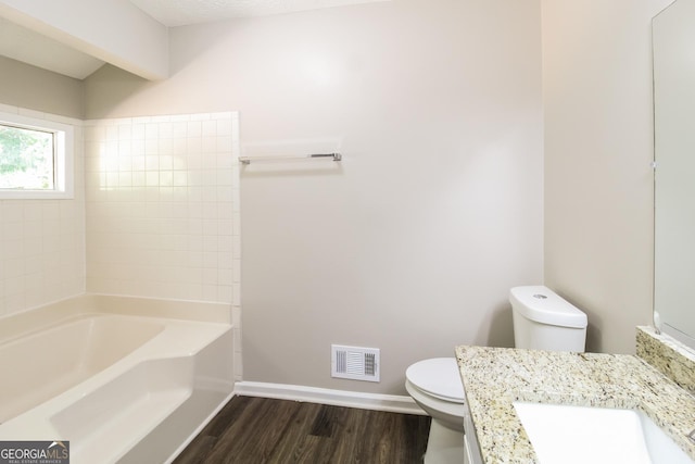 full bathroom featuring wood-type flooring, toilet, tub / shower combination, and vanity