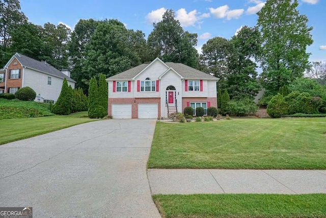 split foyer home with a garage and a front yard