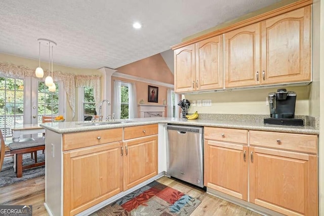 kitchen with light hardwood / wood-style floors, kitchen peninsula, decorative light fixtures, stainless steel dishwasher, and sink