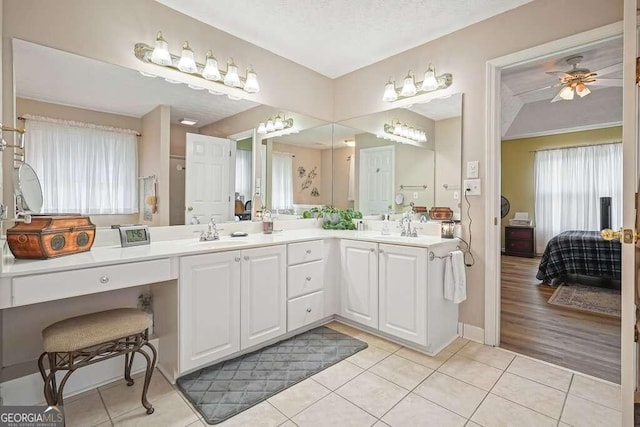 bathroom with vanity, a textured ceiling, crown molding, ceiling fan, and hardwood / wood-style floors