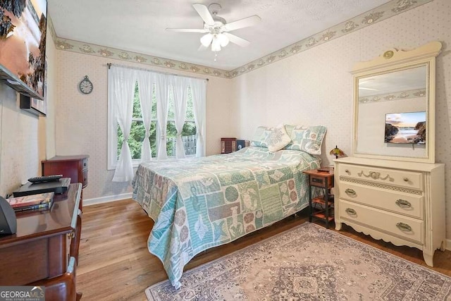 bedroom with ceiling fan and hardwood / wood-style floors